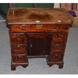 A George III mahogany kneehole deskDrawer linings go back to front. The top is faded and with some