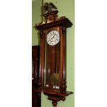 A walnut veneered double weight driven wall clock