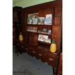 A Late George III oak and mahogany crossbanded dresser and rack, the dentil cornice above a wavy