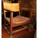 A Gomme fireside oak armchair, circa 1929, model 105, with tan hide seat and back, stamped R.E.G