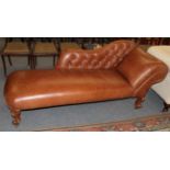 A Victorian style leather covered chaise longue