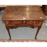 An 18th century walnut lowboyThe surfaces are discoloured and faded. The top with cracks and