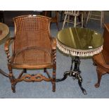 A cane seated armchair; and an ebonised tripod table