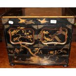 A miniature gilt lacquered cabinet with cupboard doors and drawers