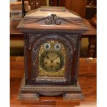 ~ Carved oak quarter striking mantel clock, movement backplate stamped Junghans