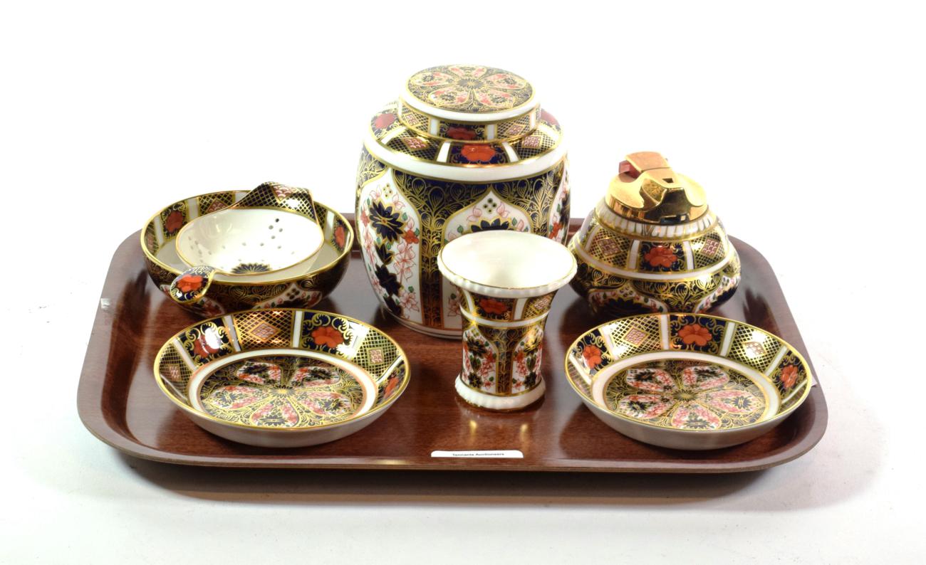 A Royal Crown Derby ginger jar and cover, a table lighter, a tea strainer, a vase and two dishes