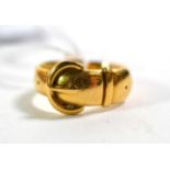An 18 carat gold buckle ring, finger size N. Gross weight 8.10 grams.