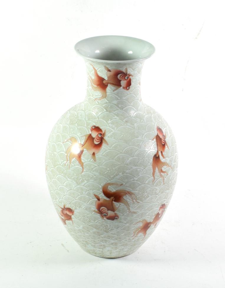 A Chinese porcelain carved vase decorated with fish