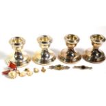 Two sets of cased dwarf candlesticks; together with two silver brooches; a pair of Majorica earrings