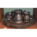 A collection of antique pewter including two chargers, two footed bowls, mugs and measures etc