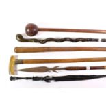 A collection of various sticks including a knobkerrie, spear, silver collared walking stick etc (7)