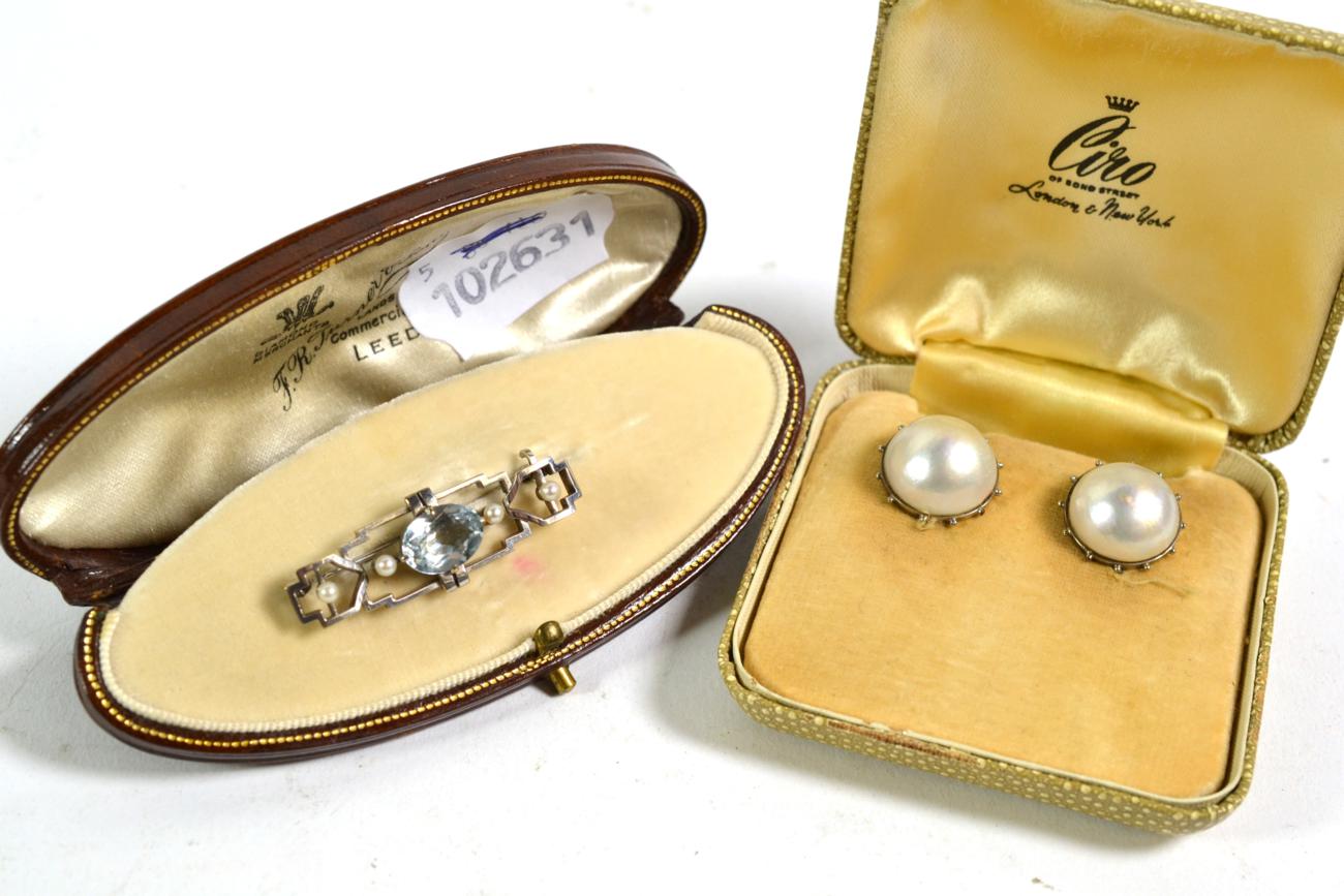 An aquamarine and seed pearl brooch, length 4cm, cased by F R Turner & Son; and a pair of pearl type