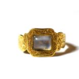 An 18 carat gold moonstone mourning ring, finger size J. Gross weight - 3.21 grams
