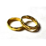 Two patterned 18 carat gold band rings, finger sizes N and O (2) . Gross weight 7.0 grams.