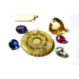 Five loose stones comprising of pink topaz, green quartz, blue glass, purple synthetic sapphire,