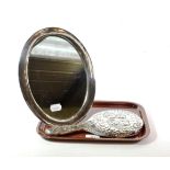 A George V silver-mounted dressing-table mirror; maker's mark rubbed, Birmingham, 1922, oval and