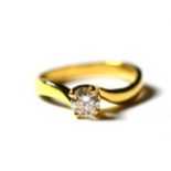 An 18 carat gold solitaire diamond ring, a round brilliant cut diamond in a yellow claw setting,