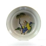 A Chinese famille vert porcelain dish decorated with an elderly man beneath a tree in the Kangxi