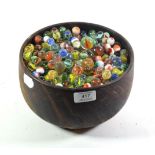 A treen bowl containing a large collection of marbles