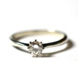 A platinum solitaire diamond ring, a round brilliant cut diamond in a claw setting, to knife edge