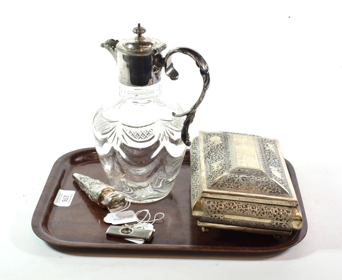 A collection of white metal including a claret jug, ceylon box, scent bottle, cigar cutter and a