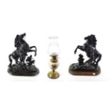 A matched pair of black painted spelter Marly horses (a.f.); and a pottery and brass oil lamp with