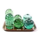 A pair of Victorian Sunderland glass candle holders and four Sunderland dump paperweights