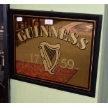 A Guinness pub advertising mirror with black, red and gilt border, 37cm by 47cm including frame