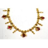 A necklace stamped '750' set with red glass stones, length 46cm . The necklace is stamped 'VI88' '