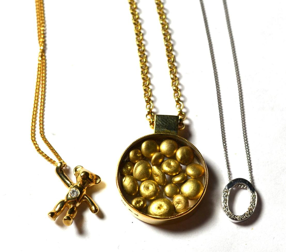 A 9 carat gold nugget pendant on a 9 carat gold chain, pendant diameter 2cm, chain length 40cm; a