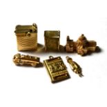 Six 9 carat gold charms/pendants including a lighter, a passport, a tanker etc. Gross weight 30.7