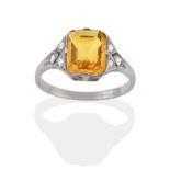 A Yellow Sapphire and Diamond Ring, in the Art Deco Style, the emerald-cut yellow sapphire in