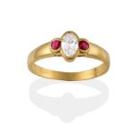 An 18 Carat Gold Diamond and Ruby Three Stone Ring, a central oval cut diamond flanked by a round