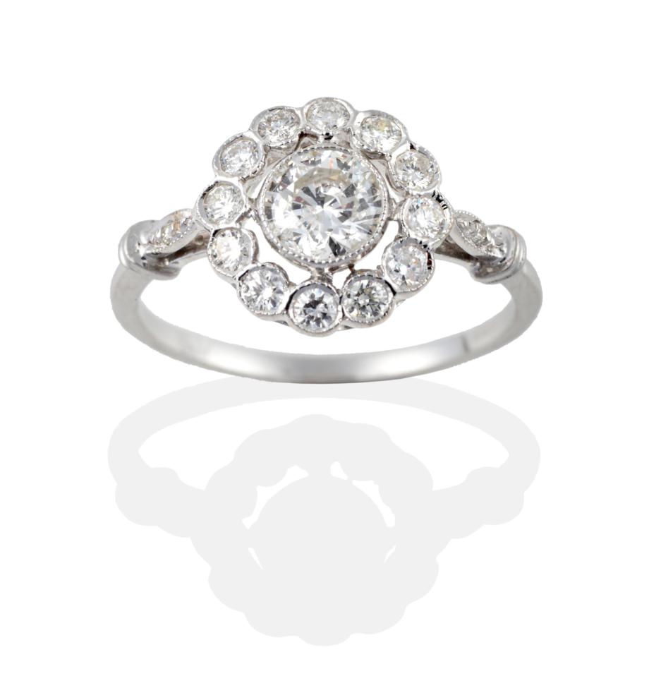 An 18 Carat White Gold Diamond Cluster Ring, the round brilliant cut diamonds in millegrain