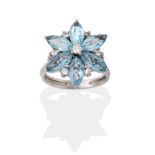An Aquamarine and Diamond Cluster Ring, a round brilliant cut diamond centres a cluster of six