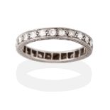 A Diamond Eternity Ring, the round brilliant cut diamonds in white channel and millegrain