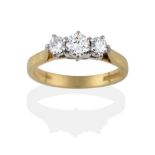 An 18 Carat Gold Diamond Three Stone Ring, the graduated round brilliant cut diamonds in white