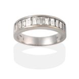 An 18 Carat White Gold Half Hoop Ring, eleven graduated baguette cut diamonds in a channel