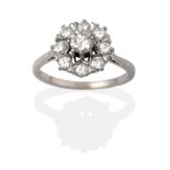 A Diamond Cluster Ring, the round brilliant cut diamonds in white claw settings to a tapered