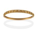 A 14 Carat Gold Bangle, of decorative form, one half with a diamond and several split pearls inset