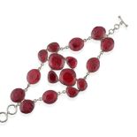 An Abstract Ruby Bracelet, mixed cut rubies in white rubbed over settings arranged in two strands