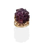 An Amethyst Crystal Ring, the amethyst of natural form, in a textured leaf motif and bead setting,