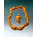 An Amber Necklace, comprising of one hundred and thirteen irregular shaped and sized orangey-