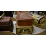 Seven assorted vintage suitcases, including two pigskin cases (7)