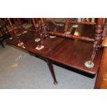 George II mahogany gateleg dining table, raised on tapering legs with pad feet. Discoloured