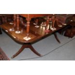 ^ A Regency style mahogany twin pedestal dining table