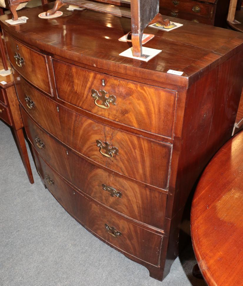 ^ A Regency mahogany and cross-banded five drawer bow fronted chest of drawers, 100cm wide