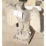 A composition garden statue in the form of an eagle with wings half spread