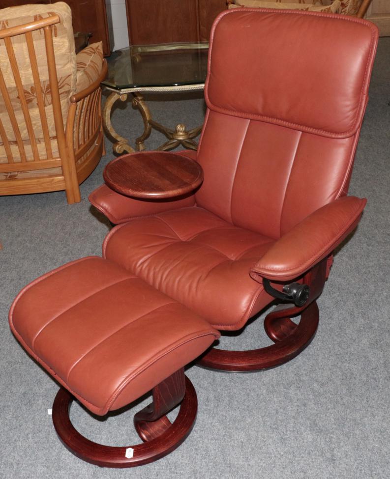 An Ekornes Stressless Swivel Armchair, modern, the stained beech frame with padded back support