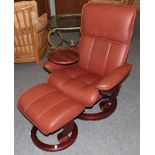 An Ekornes Stressless Swivel Armchair, modern, the stained beech frame with padded back support